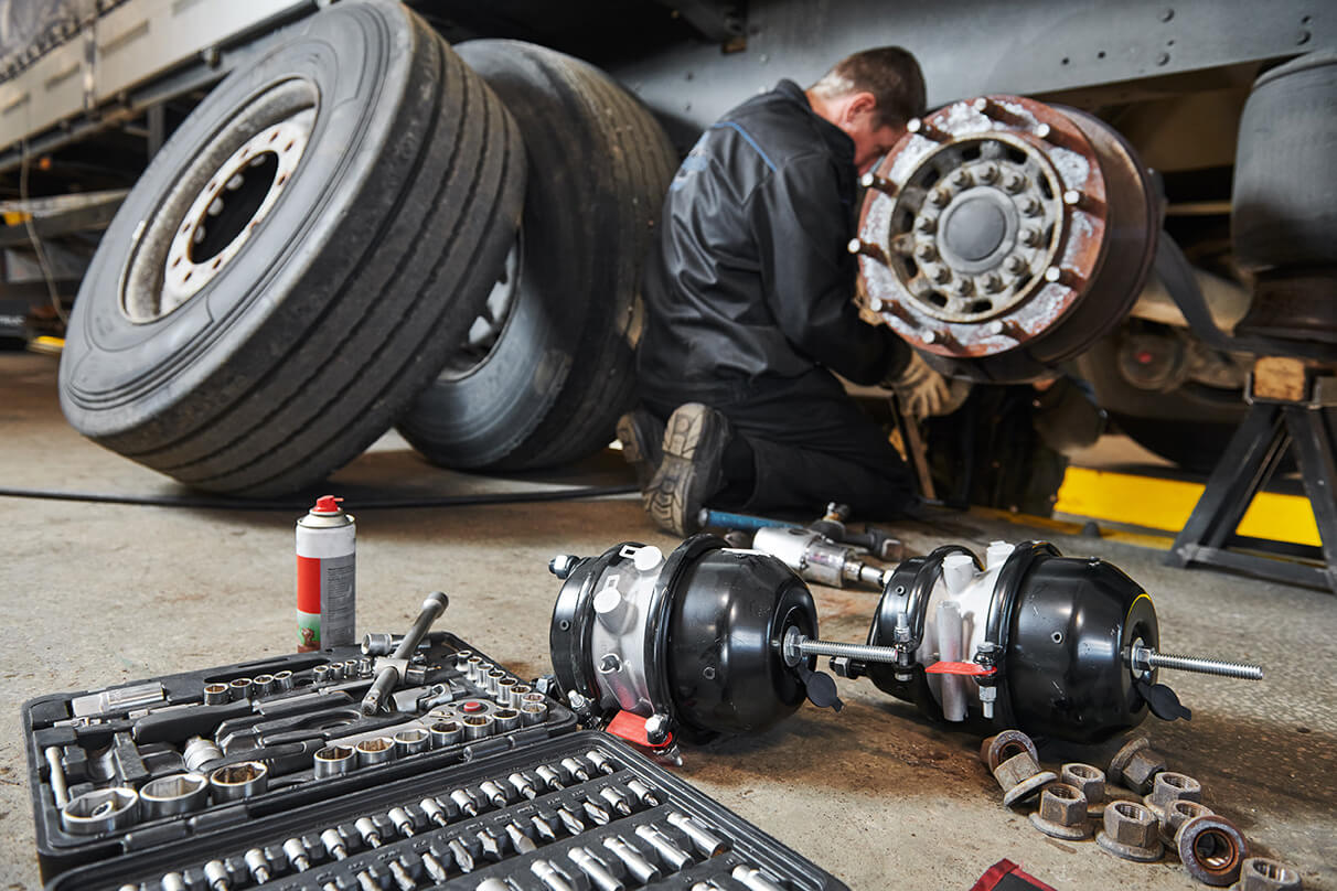 Professional fleet maintenance technician working on a commercial truck